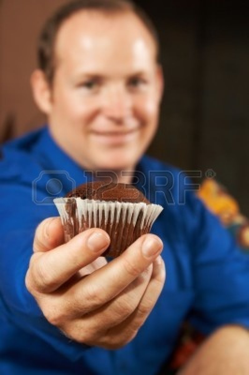 997993-sexy-young-man-in-blue-shirt-offering-you-a-chocolate-chip-muffin-shallow-depth-of-field--muffin-is-.jpg