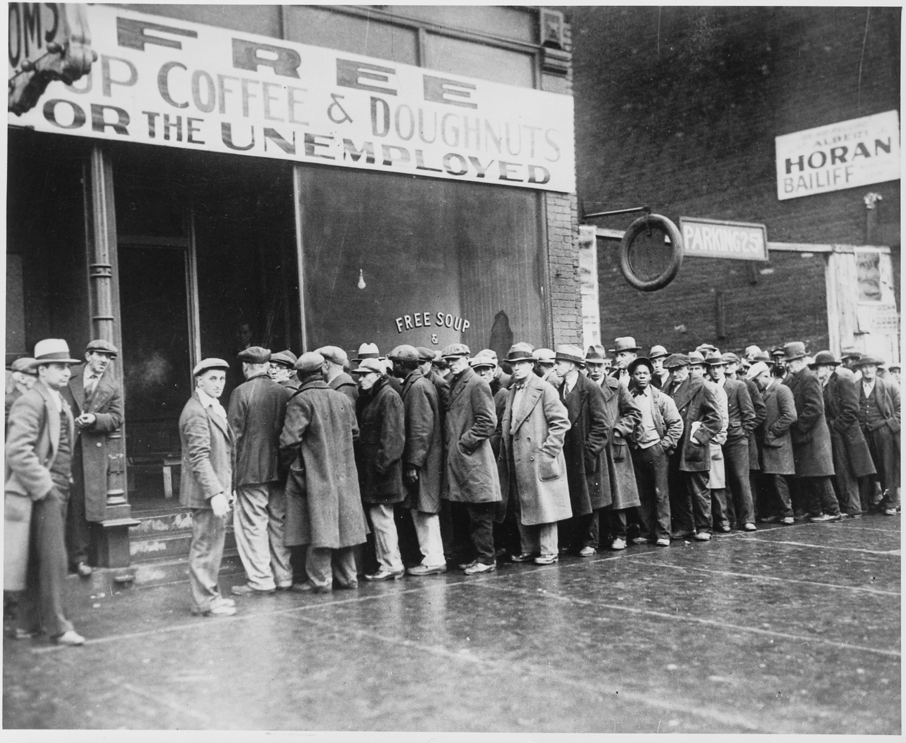 Unemployed_men_queued_outside_a_depression_soup_kitchen_opened_in_Chicago_by_Al_Capone,_02-1931_-_NARA_-_541927.jpg